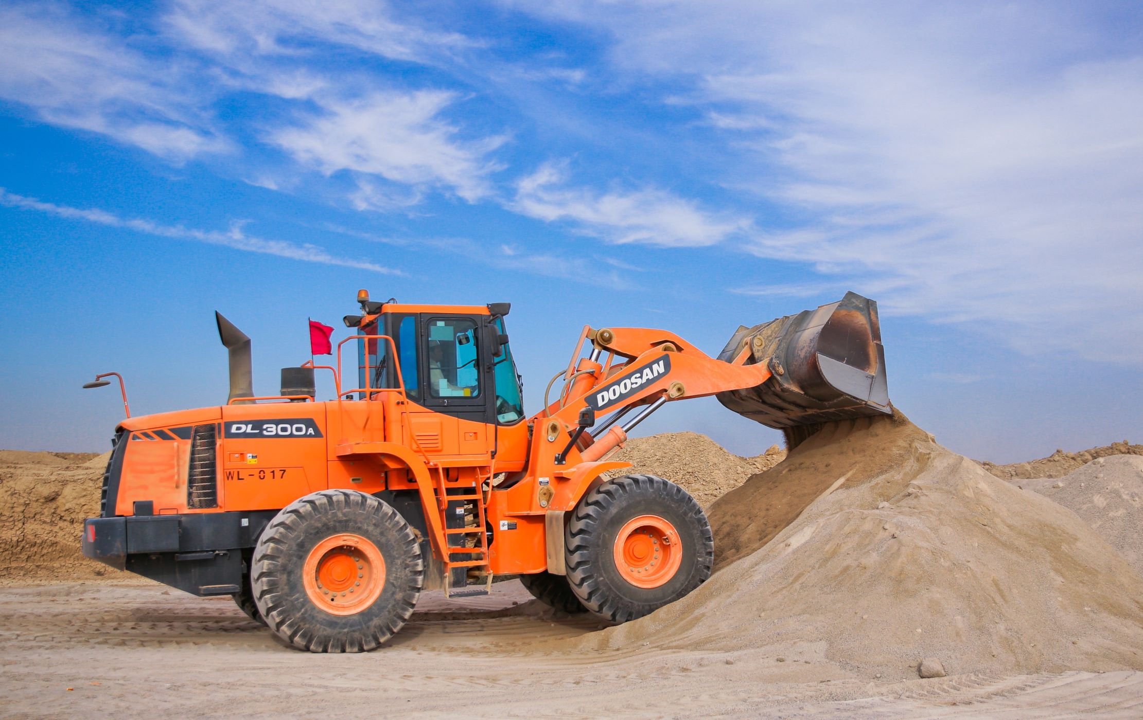 orange-excavator-on-brown-hill-1116035